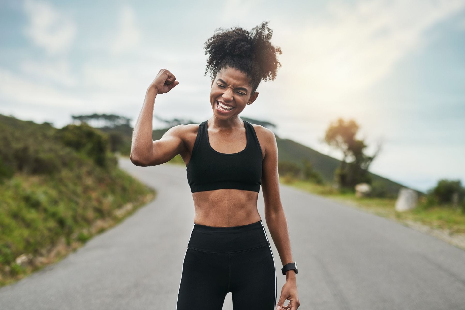 Runner flexing her arm